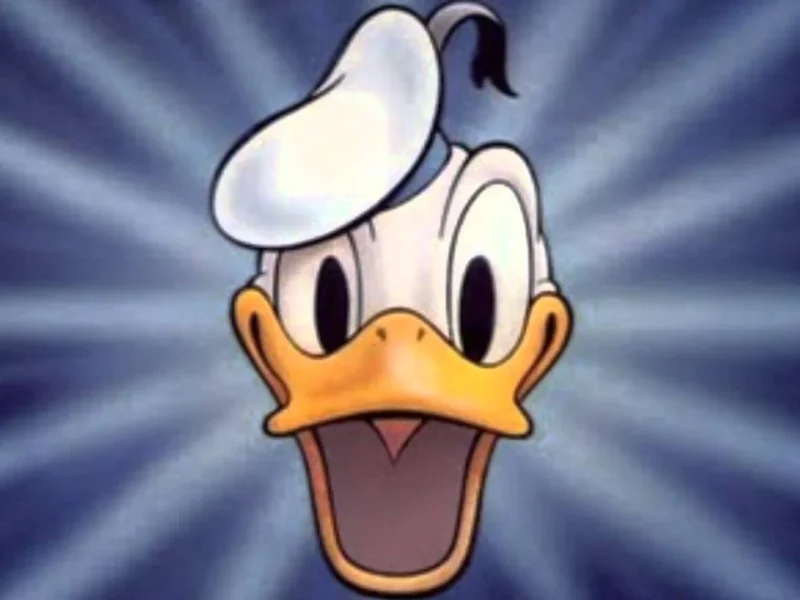 Une illustration de Donald Duck avec une expression choquée grande ouverte, sur un fond rayonnant bleu dynamique. Il porte son chapeau de marin classique avec un pompon noir.