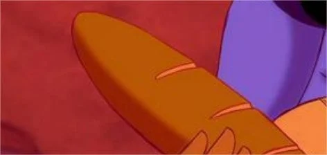 Un gros plan de la main d'un personnage animé tenant une longue miche de pain orange sur un fond rouge-violet dans une production de Disney Films.