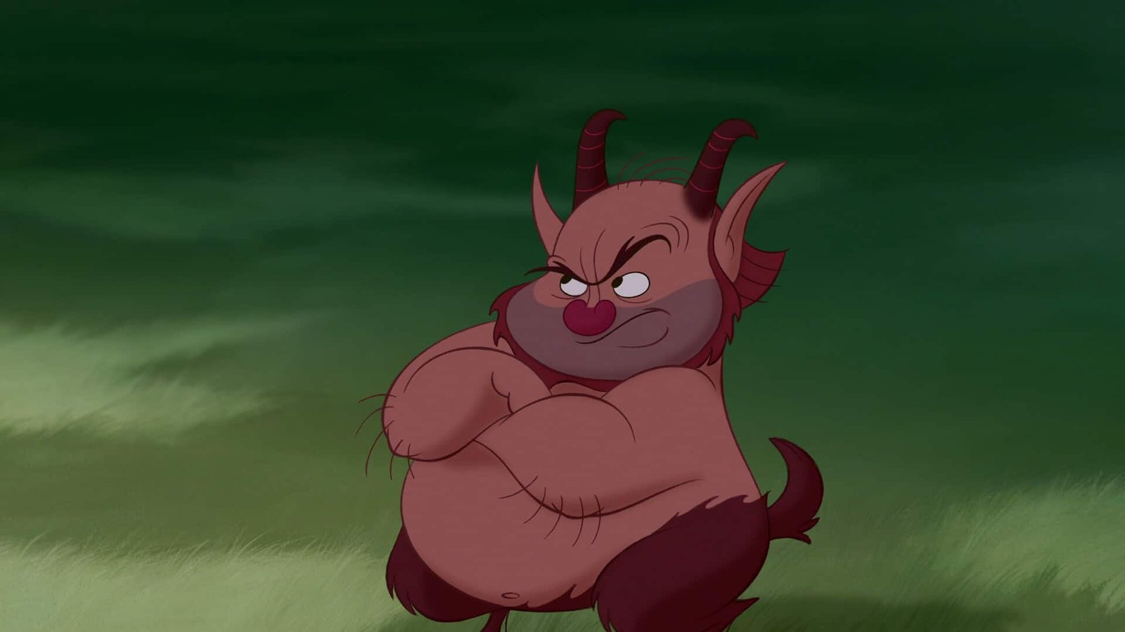 Image animée d'un personnage dodu et diabolique avec un sourire malicieux, une peau rouge foncé et de petites cornes, debout, les bras croisés sur un fond vert, ressemblant à des personnages de Disney.