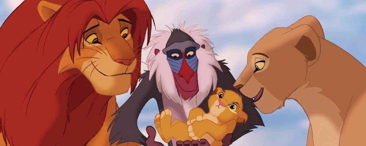Une scène de "Le Roi Lion" montrant les lions adultes Simba et Nala, avec le mandrill Rafiki tenant leur petit alors qu'ils les regardent affectueusement.