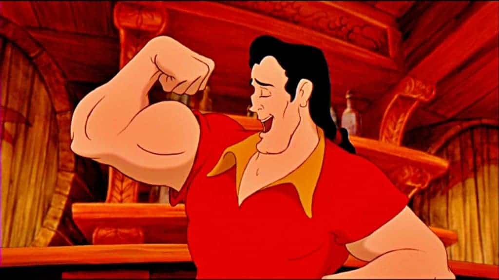 Personnage animé Gaston de « La Belle et la Bête », l'un des méchants de Disney, fléchissant ses biceps avec un sourire narquois dans une taverne, montrant sa musculature. Il porte un