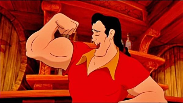 Personnage animé Gaston de « La Belle et la Bête », l'un des méchants de Disney, fléchissant ses biceps avec un sourire narquois dans une taverne, montrant sa musculature. Il porte un