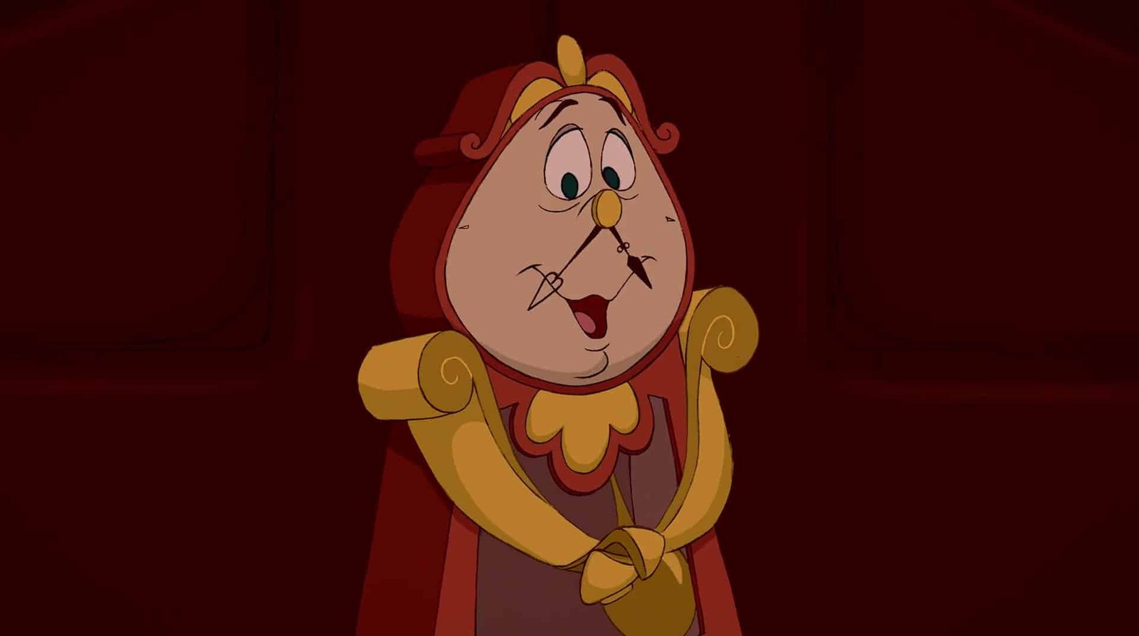 Une image animée de Cogsworth, le personnage de l'horloge de Disney's Beauty and the Beast, l'air surpris avec ses mains jointes. Il a un visage rond, une moustache blanche et porte