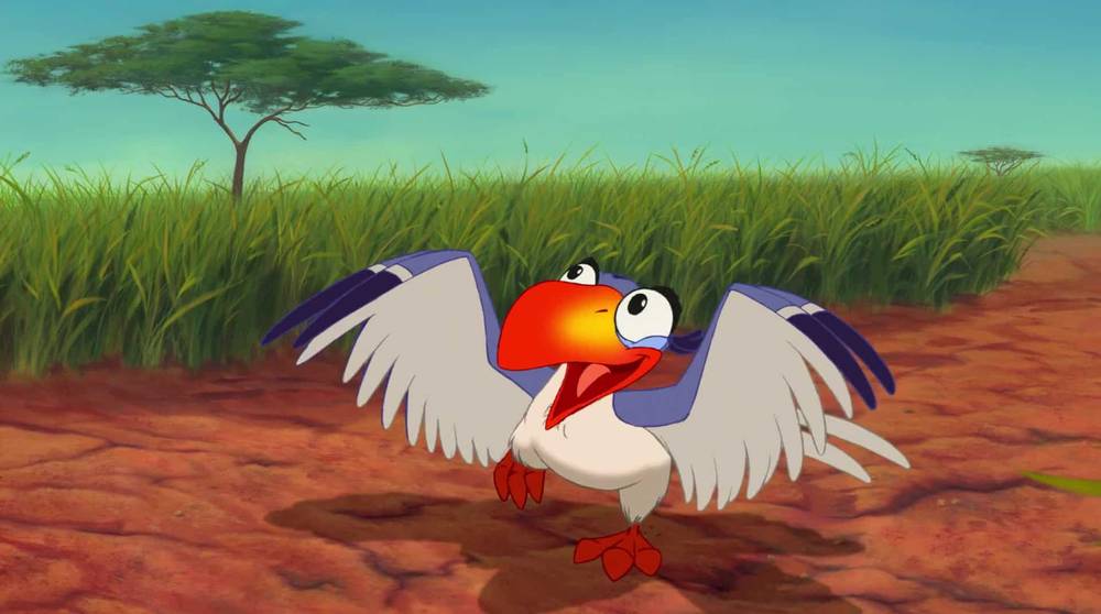Un oiseau animé coloré, un « oiseau », avec un grand bec rouge et des plumes blanches, bat des ailes avec enthousiasme dans un décor de savane avec des herbes hautes et un seul arbre en arrière-plan.