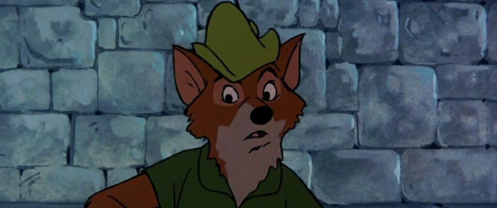 Un renard animé portant un chapeau et une chemise vertes, semblant surpris ou inquiet, rappelant Robin des Bois, se tient devant un mur de pierre grise.