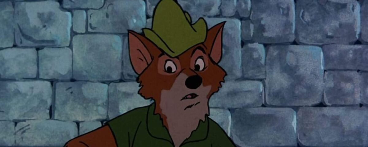 Un renard animé portant un chapeau et une chemise vertes, semblant surpris ou inquiet, rappelant Robin des Bois, se tient devant un mur de pierre grise.