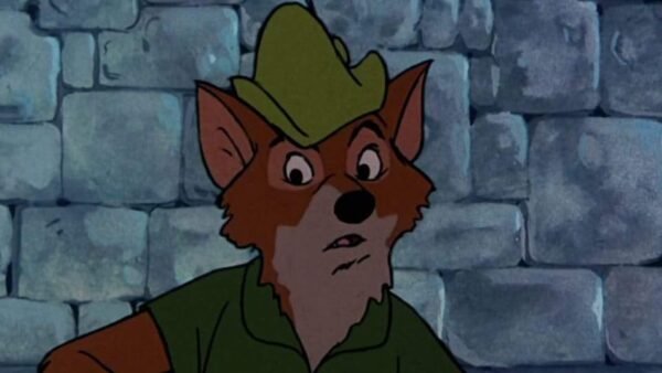 Un renard animé portant un chapeau et une chemise vertes, semblant surpris ou inquiet, rappelant Robin des Bois, se tient devant un mur de pierre grise.