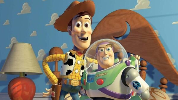 Personnages animés Woody et Buzz l'Éclair de "Toy Story" debout dans une chambre d'enfant, souriant sur un fond fantaisiste comportant des nuages et un chapeau de cowboy géant.