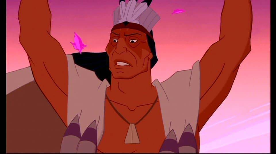 Image animée d'un chef amérindien aux bras levés, portant une coiffe à plumes, sur un ciel de coucher de soleil violet de style Disney avec des feuilles roses volantes.