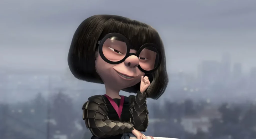 Personnage animé de "Les Indestructibles", une femme avec une coupe de cheveux au carré et de grandes lunettes rondes, touchant pensivement sa joue, avec une ligne d'horizon floue en arrière-plan.