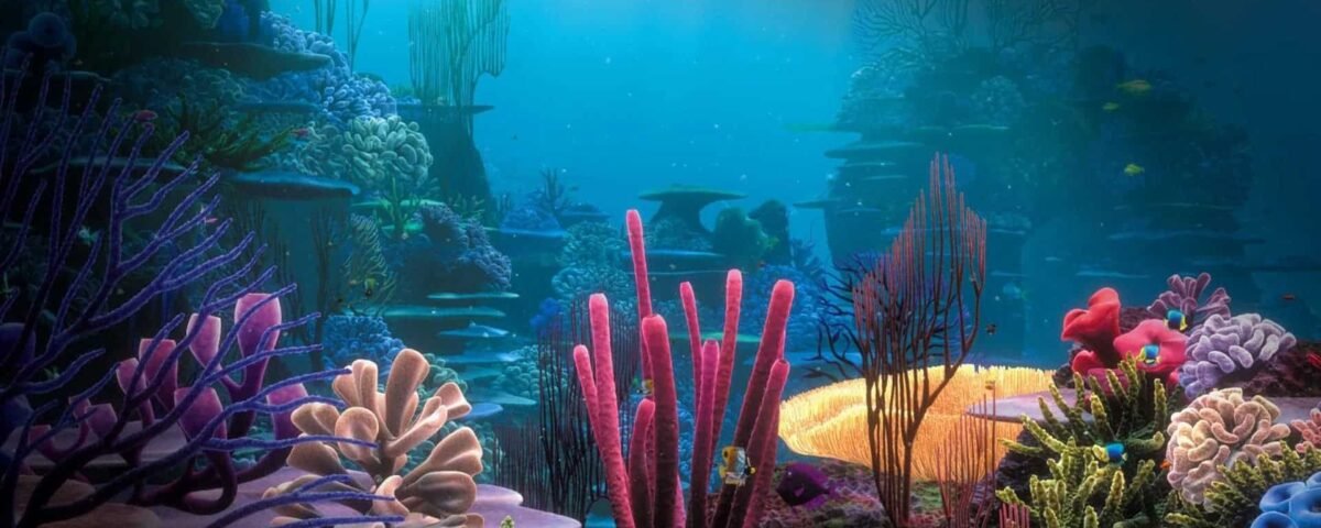 Scène sous-marine vibrante inspirée du « Monde de Nemo », représentant un large éventail de coraux et de plantes marines de différentes couleurs et formes, illuminés par la lumière naturelle filtrant à travers l'eau.