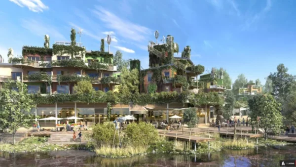 Rendu architectural d'un bâtiment moderne de plusieurs étages recouvert d'un écrin de verdure avec balcons et terrasses. On voit des gens profiter des espaces extérieurs et d’un front de mer naturel semblable à un étang dans un village