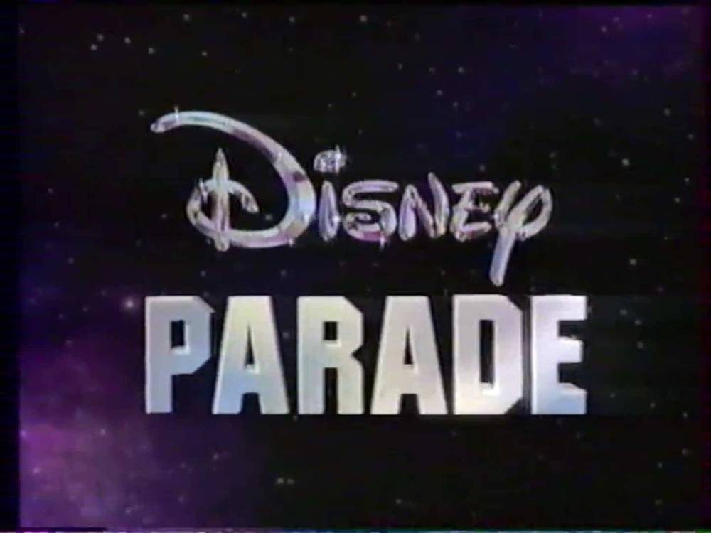 Le logo de « Disney Parade » présente un script « Disney » stylisé avec un fond d'étoiles scintillantes, évoquant un ciel nocturne, soulignant le thème magique du spectacle.