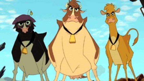 Trois vaches animées du film "La Ferme se Rebelle" debout dans un paysage désertique ; un noir, un marron et un beige, tous portant des cloches.