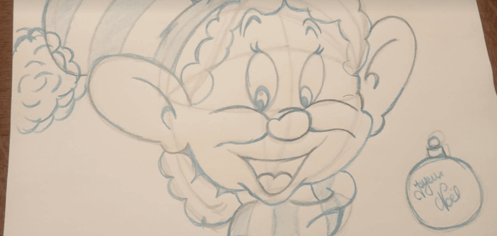 Croquis au crayon d'un elfe joyeux de bande dessinée avec un grand sourire, portant un simple chapeau. À côté de l'elfe, une décoration de Noël inscrite « Joyeuses fêtes » est dessinée.