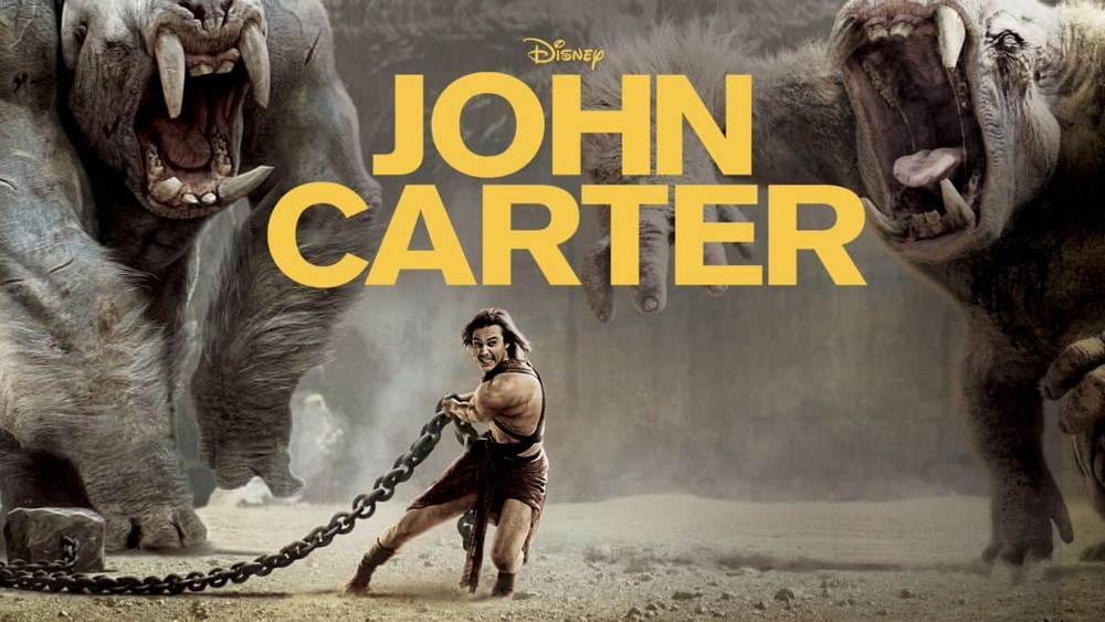Image promotionnelle pour "John Carter" montrant le personnage principal, interprété par Taylor Kitsch, dans une pose dynamique, tenant des chaînes avec deux grandes créatures extraterrestres féroces en arrière-plan.
