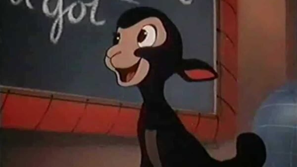 Image de bande dessinée représentant un âne anthropomorphe heureux debout devant un tableau noir avec les mots partiellement visibles « Danny le petit mouton noir » écrits à la craie.