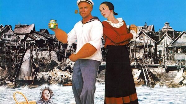 Affiche du film "Popeye" mettant en vedette Robin Williams dans le rôle de Popeye et Shelley Duvall dans le rôle d'Olive Oyl, debout devant un village balnéaire rustique avec un panier de pique-nique au premier plan.