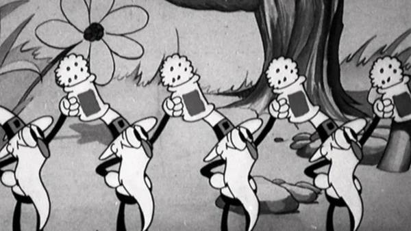 Image animée en noir et blanc tirée de "Silly Symphonies" montrant une file de pissenlits de dessins animés portant des chaussures et des gants, chacun tenant une valise, marchant dans un décor forestier fantaisiste.