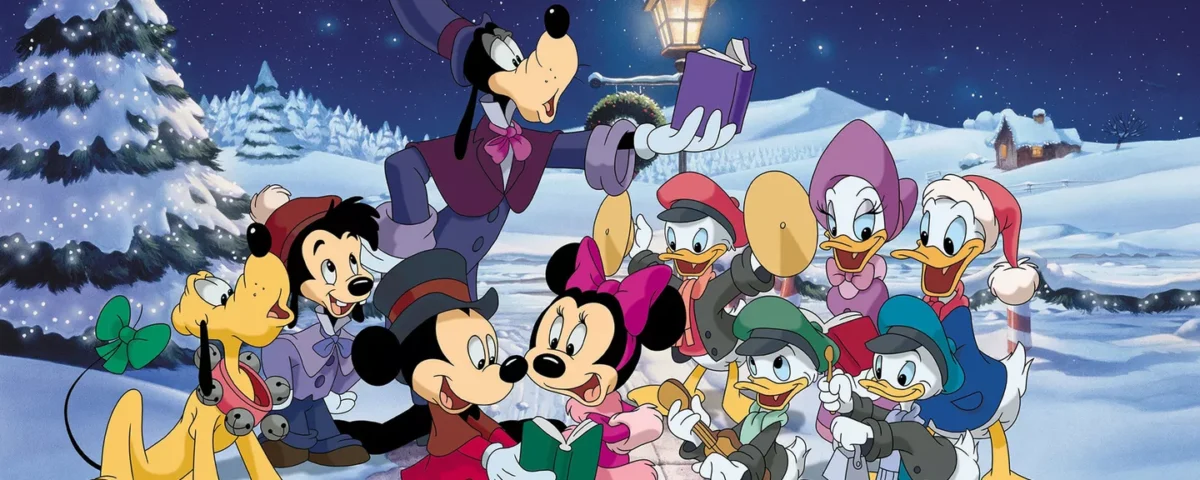 Une scène de Noël festive avec des personnages Disney dont Mickey, Minnie, Donald et Dingo chantant joyeusement des chants de Noël près d'un lampadaire dans un paysage enneigé la nuit.