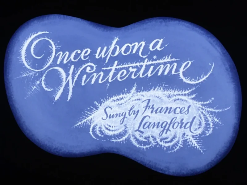 Un fond bleu en forme de nuage avec l'expression « Il était une fois l'hiver » écrite en élégante cursive blanche, inspirée de Disney. Ci-dessous, "chanté par Frances Langford" est inscrit