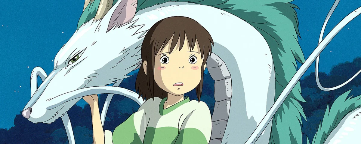 Une scène d'un film de Miyazaki montrant une jeune fille vêtue d'un haut vert et blanc, l'air surprise à côté d'une grande créature mythique blanche avec de longues moustaches et des dents pointues sur un ciel nocturne.