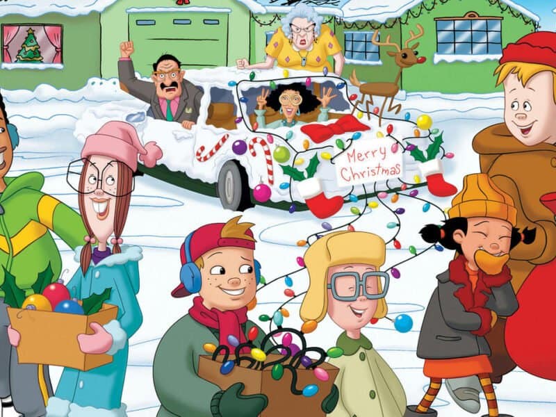 Illustration d'un groupe diversifié de personnes profitant des activités de Noël dans un décor enneigé, avec des décorations colorées, des tenues de fête et une pancarte « joyeux Noël » sur une voiture.