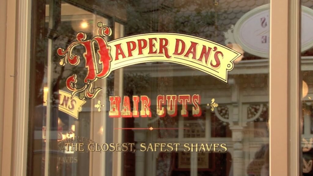 Une pancarte dans la vitrine d'un salon de coiffure proposant des coupes de cheveux Dapper's Dan.
