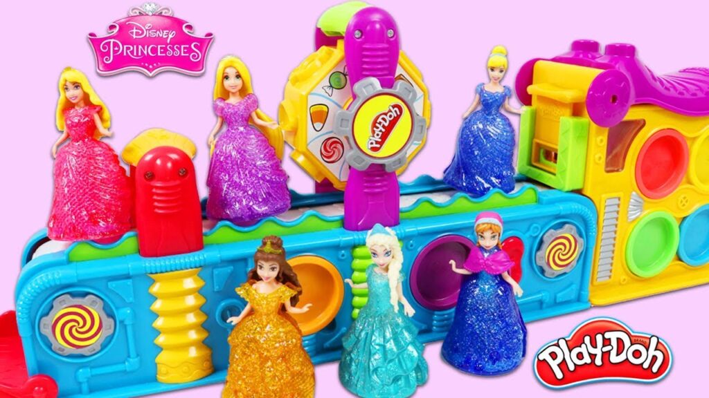 Jeu Hasbro Play-Doh coloré avec des figurines de princesses Disney, dont Raiponce, Cendrillon, Belle, Elsa et d'autres, présentées sur un fond rose.