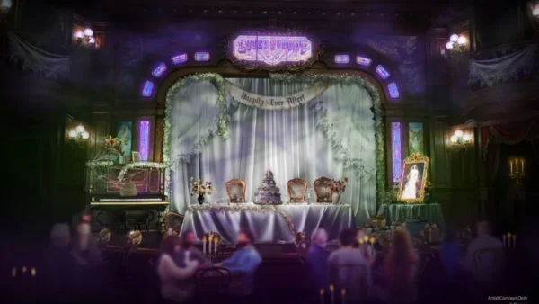 Une salle ornée et faiblement éclairée de Disneyland Paris présente une table décorée sur une scène, un piano, des couronnes festives et un portrait inquiétant - capturant l'esprit d'Halloween Disney 2025 - avec des invités assis au premier plan.
