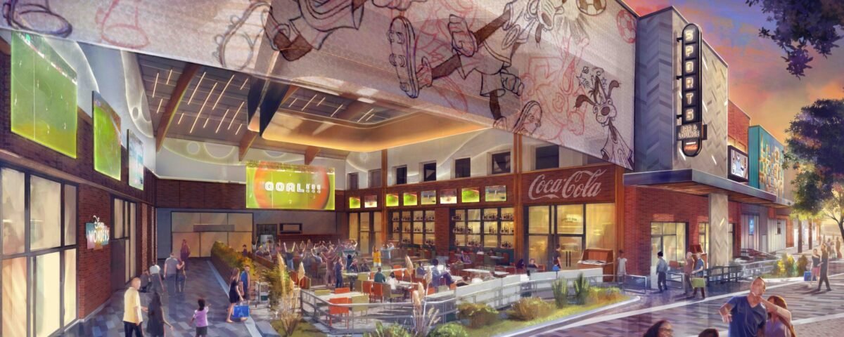 Un espace de restauration en plein air animé à Disney Village avec des personnes assises à des tables, de grands écrans de sport et une fresque de personnages de dessins animés au-dessus du bâtiment - parfait pour profiter de l'atmosphère vibrante de ce Sports Bar & Lounge près de Disneyland Paris.