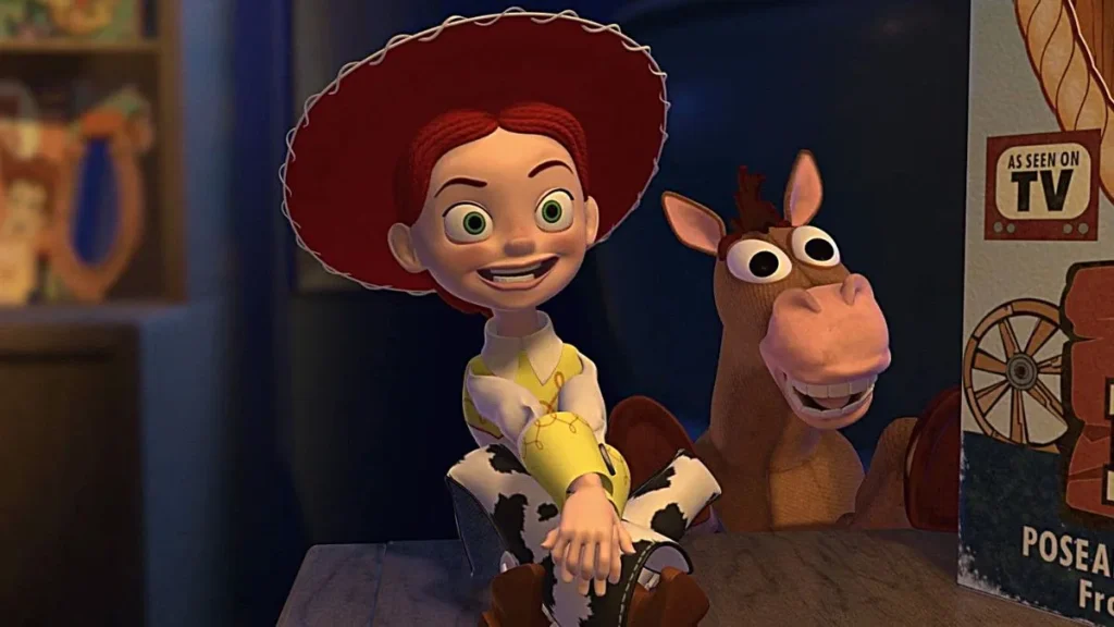 Le personnage animé Jessie, coiffée d'un chapeau rouge et vêtue d'un pantalon de vache, sourit à Bullseye, le cheval, dans une scène de Toy Story 5, dont la sortie est prévue en 2026.