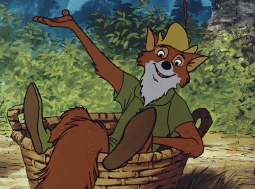 Le renard animé en chemise et chapeau verts, inspiré par Robin des Bois, est assis dans un panier tressé, un bras levé, entouré d'un feuillage luxuriant - une scène qui rappelle la première du film le 8 novembre 1973.