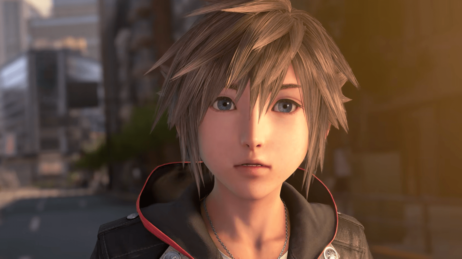 Un personnage d'animation aux cheveux bruns hérissés et aux yeux bleus se tient dans une rue de la ville, vêtu d'une veste noire doublée de rouge, le regard tourné vers l'avant avec une expression neutre, rappelant le style emblématique de Kingdom Hearts que l'on retrouve dans la série animée diffusée sur Disney+.