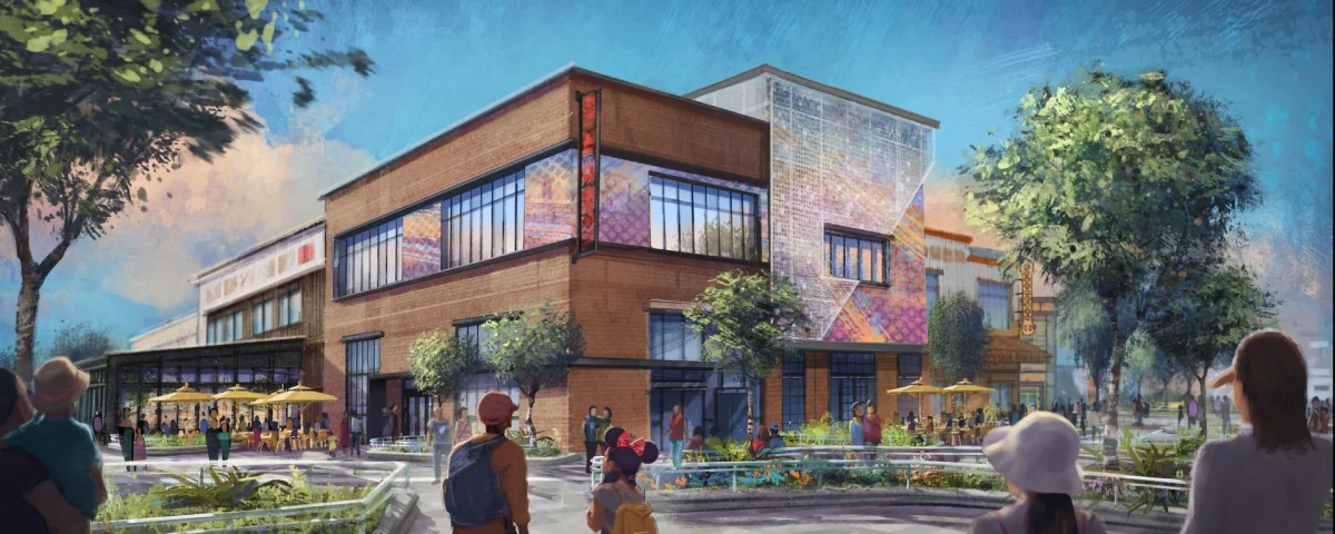 Une image de synthèse montre des passants marchant près d'un immeuble commercial moderne de deux étages, doté d'une terrasse, d'arbres et de touches de couleurs, sous un ciel bleu, illustrant ainsi une transformation dynamique qui rappelle le Disney Village de Disneyland Paris.