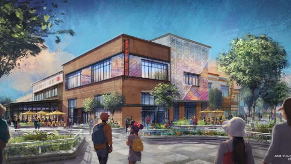 Une image de synthèse montre des passants marchant près d'un immeuble commercial moderne de deux étages, doté d'une terrasse, d'arbres et de touches de couleurs, sous un ciel bleu, illustrant ainsi une transformation dynamique qui rappelle le Disney Village de Disneyland Paris.