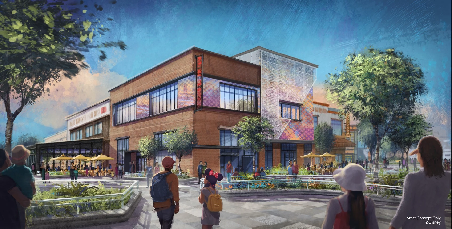 Une image de synthèse montre des passants marchant près d'un immeuble commercial moderne de deux étages, doté d'une terrasse, d'arbres et de touches de couleurs, sous un ciel bleu, illustrant ainsi une transformation dynamique qui rappelle le Disney Village de Disneyland Paris.